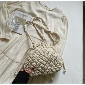 Detailed close-up of ivory hand-woven bucket bag featuring hollow crochet diamond patterns
