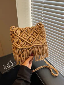 Handmade bohemian woven shoulder bag with long fringe and geometric patterns for beach holidays