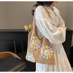 Detail view of handmade crochet tote bag with colorful 3D floral embroidery patterns