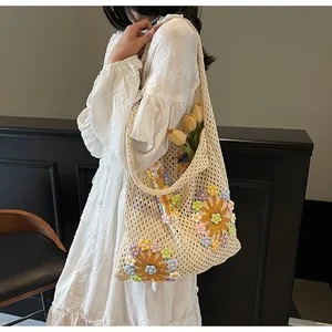 Detail of hollow-out knit shoulder bag with colorful 3D floral crochet appliques