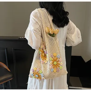 Close-up of handmade crochet hollow mesh tote bag with 3D colorful floral decorations