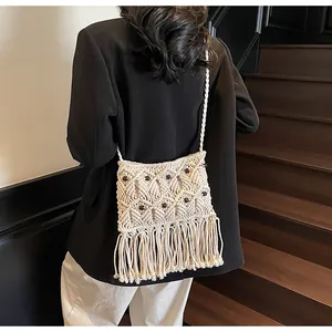 Detailed shot of bohemian hand-woven crossbody bag with fringe and wooden beads