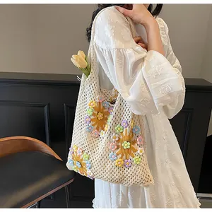 Detailed knit of beige crochet tote with 3D sunflowers and colorful floral accents
