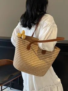 French style straw woven tote bag with brown leather handles for summer beach vacations