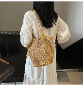 Bolso de hombro de malla de punto marrón claro en un modelo en un estilo minimalista