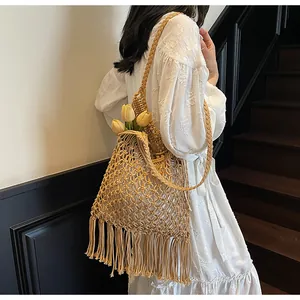 Detail of bohemian hand-woven shoulder bag with tassels and large mesh crochet patterns