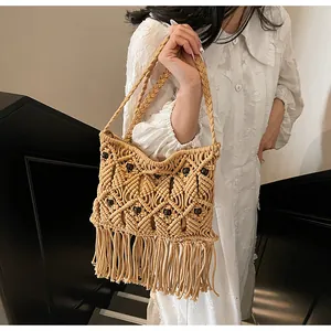 Detail of bohemian macrame bag with hand-woven diamond patterns and wooden beads décor