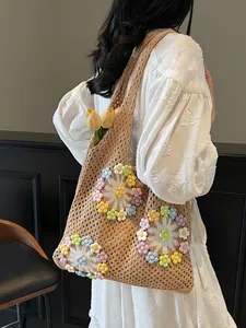 Bohemian crochet knit shoulder bag with colorful floral patterns on white dress