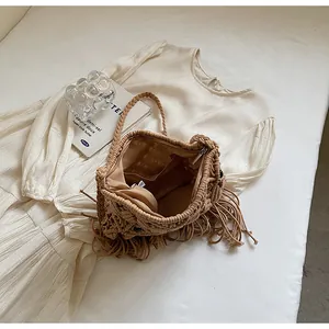 Detailed view of handmade woven tassel bucket bag featuring inner pocket and zip closure