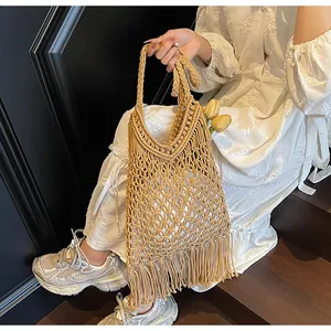 Detail of bohemian hand-woven macrame bag with long fringe and intricate tassel texture
