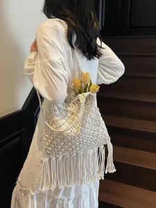 Bohemian white woven shoulder bag with long tassels and hollow knit cotton design