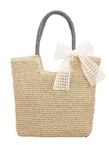 Straw beach tote with white lace bow and striped handles for summer fashion