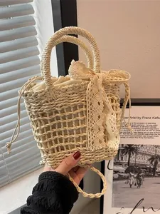 Bolso de paja tejido hueco con lazo de encaje para vacaciones de playa y verano