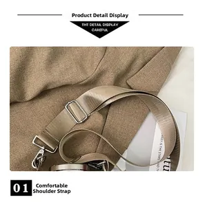 Detail of adjustable nylon shoulder strap with silver metal swivel hooks for crossbody bag