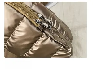 Detail of smooth double metal zippers on bronze metallic quilted crossbody bag