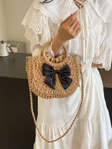 Bolso de playa de paja tejido a mano con gran lazo negro y forro con cordón ajustable