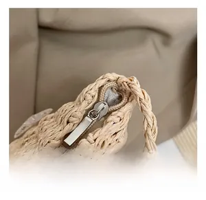 Détail de la fermeture éclair en métal et de la texture tissée du sac de plage beige