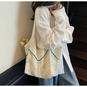Detailed close-up of white crochet knit tote bag showing intricate geometric pattern texture