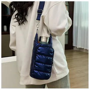 Detail of quilted down water bottle bag in shiny deep blue with adjustable strap