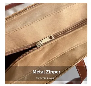 Detail view of the secure metal zipper and high-quality woven texture on this tote bag