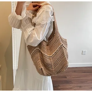 Detailed close-up of large crochet knit tote bag with bohemian hollow wave pattern