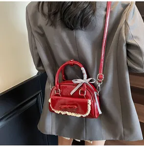 Red bow bowling bag with lace trim and checkered ribbon detail shown on a model