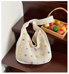 Detailed knit shoulder bag featuring colorful pearl beads and white crochet texture