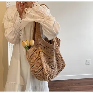 Detail of hand-woven crochet shoulder bag with yellow stitching and boho texture
