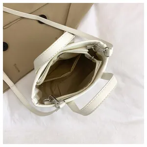 Top view of white PU leather bucket bag showing internal lining and silver hardware