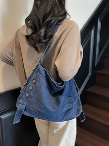 Large capacity denim shoulder bag with irregular design and metal buttons for casual commute