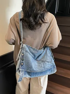 Large capacity denim blue crossbody tote bag with washed vintage style on model back