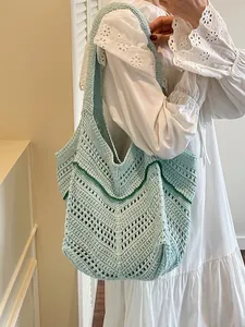Light blue large knit shoulder bag with hollow crochet pattern for beach and vacation