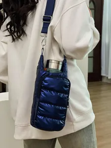 Navy blue quilted puffer water bottle crossbody bag with adjustable wide shoulder strap