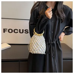 Detail der böhmischen weißen Mesh-Webtasche mit runden Holzgriffen und Kordelzugbeutel