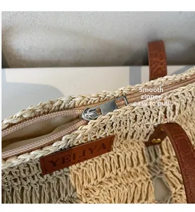 Detailed close-up of smooth metal zipper and premium inner lining on straw beach bag