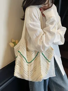 Chic knit shoulder bag in beige with green wave trim and hollow floral pattern