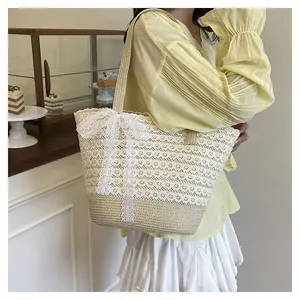 Detail of the woven straw tote with delicate white lace finish and a large decorative bow