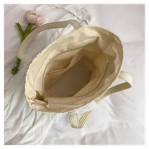 Detailed interior of beige lace tote bag showing zipper pocket and spacious lining