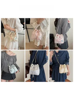 Detailed views of embroidered bucket bags featuring pearl handles and floral patterns