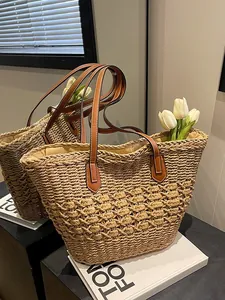 Summer woven straw tote bag with brown leather handles and textured diamond pattern