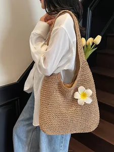 Large khaki straw tote bag with frangipani flower for beach vacations and casual use