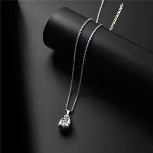 Collier avec pendentif gant de boxe argenté poli et chaîne en acier sur fond noir