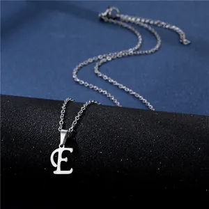 Macro detail of silver stainless steel letter E pendant necklace with lobster clasp