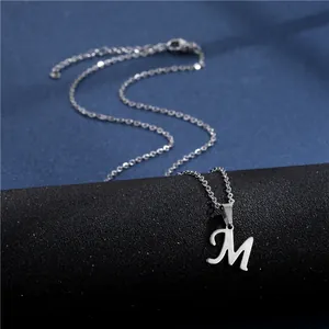 Detail of silver letter M pendant with polished finish and adjustable lobster clasp chain