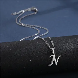 Close-up of polished stainless steel letter N pendant necklace on a jewelry display