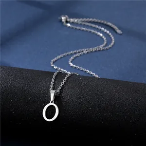 Macro shot of polished silver letter O pendant on a fine stainless steel chain