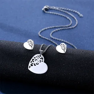Polished heart jewelry set with cutout vine patterns on necklace and stud earrings
