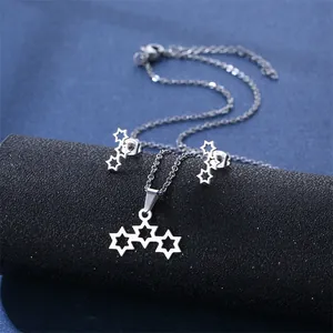 Polished silver hexagram necklace and earrings set displayed on a sleek black stand