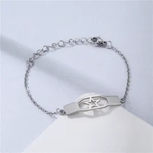 Minimalist stainless steel bracelet with geometric star plate on a white pedestal