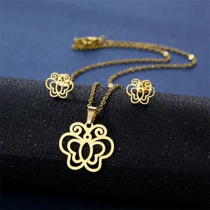 Elegant gold butterfly jewelry set with necklace and stud earrings on black stand